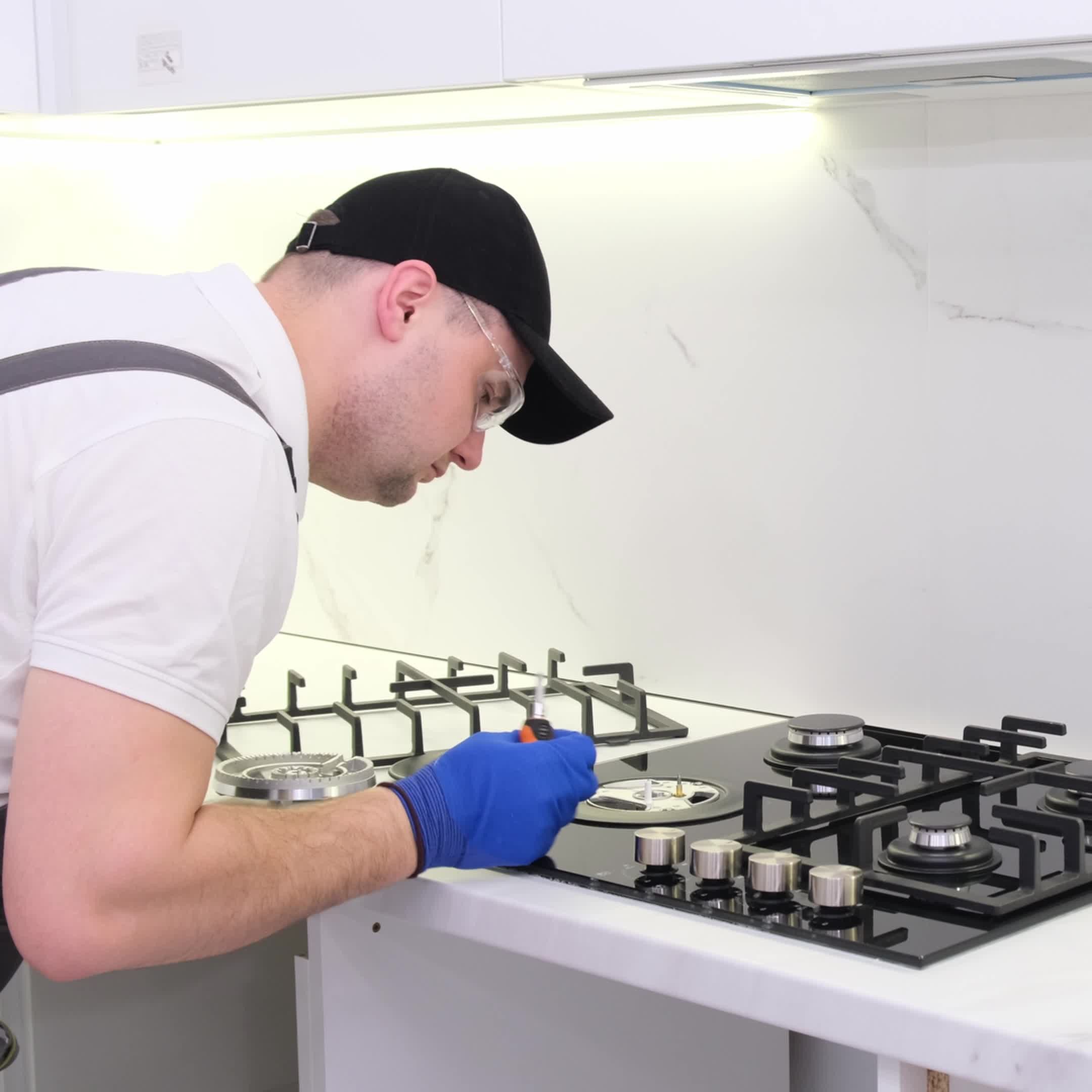 Technician repairing kitchen gas stove