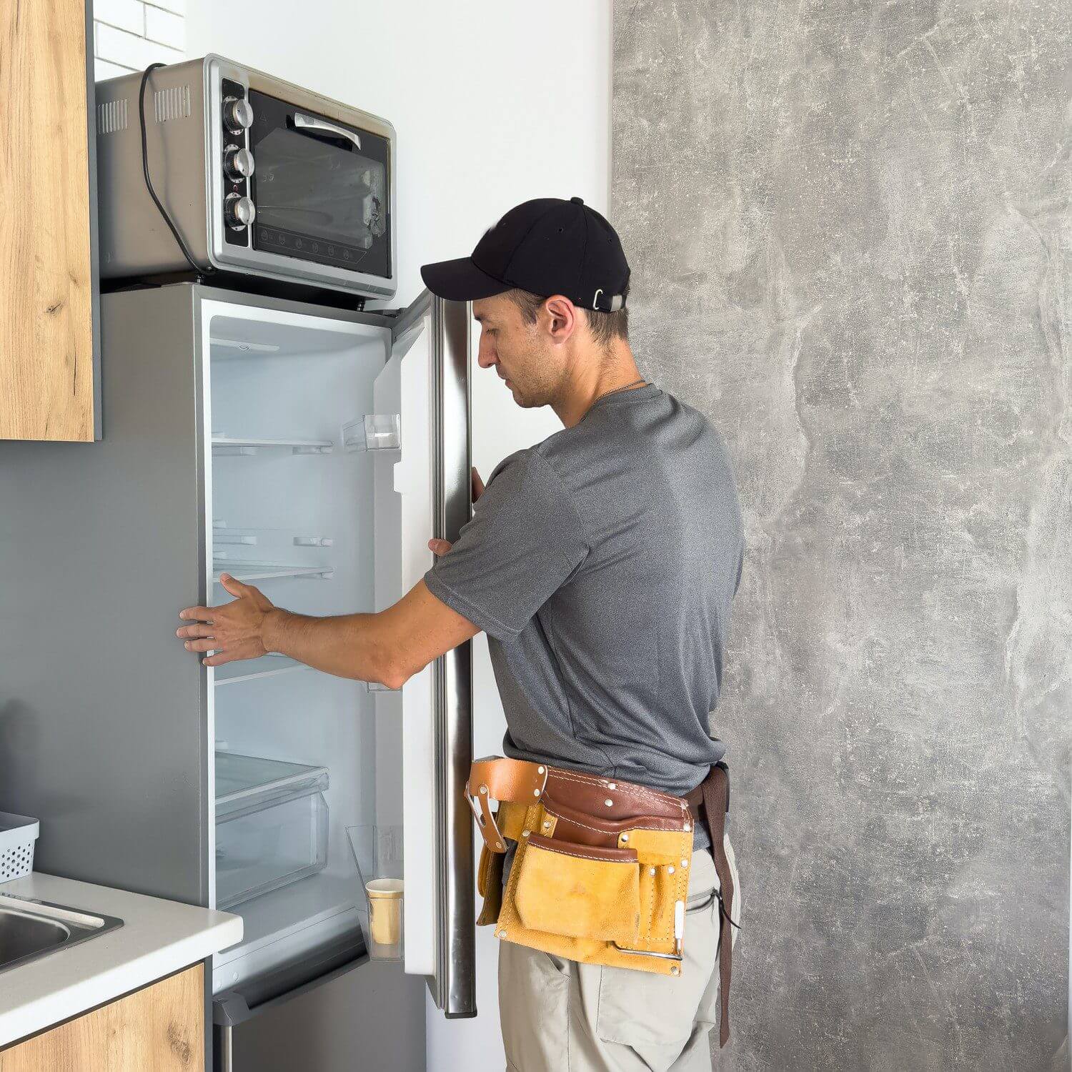 Man examining kitchen appliance