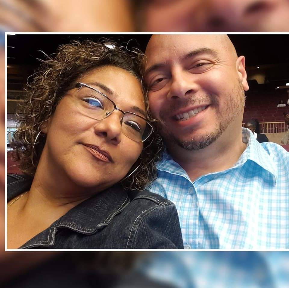Couple smiling closely together for a selfie.