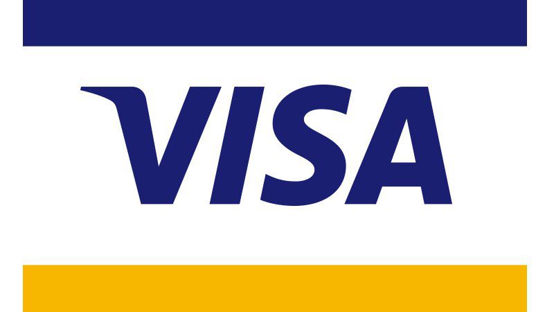 Partial view of the Visa logo with blue text on a white and yellow background.