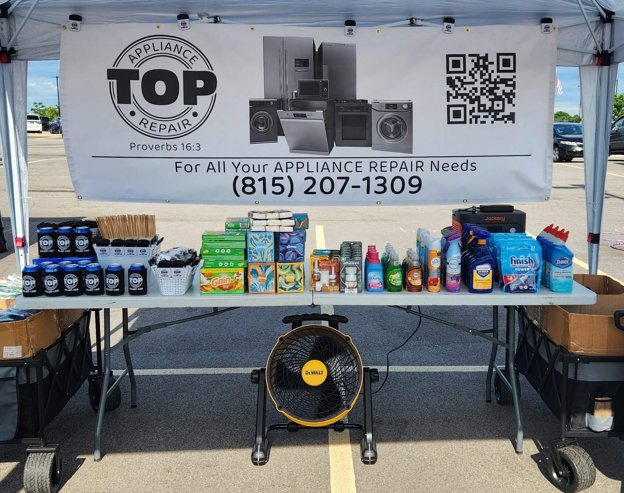 A table with various pet supplies displayed under a banner for Top Pet Air.